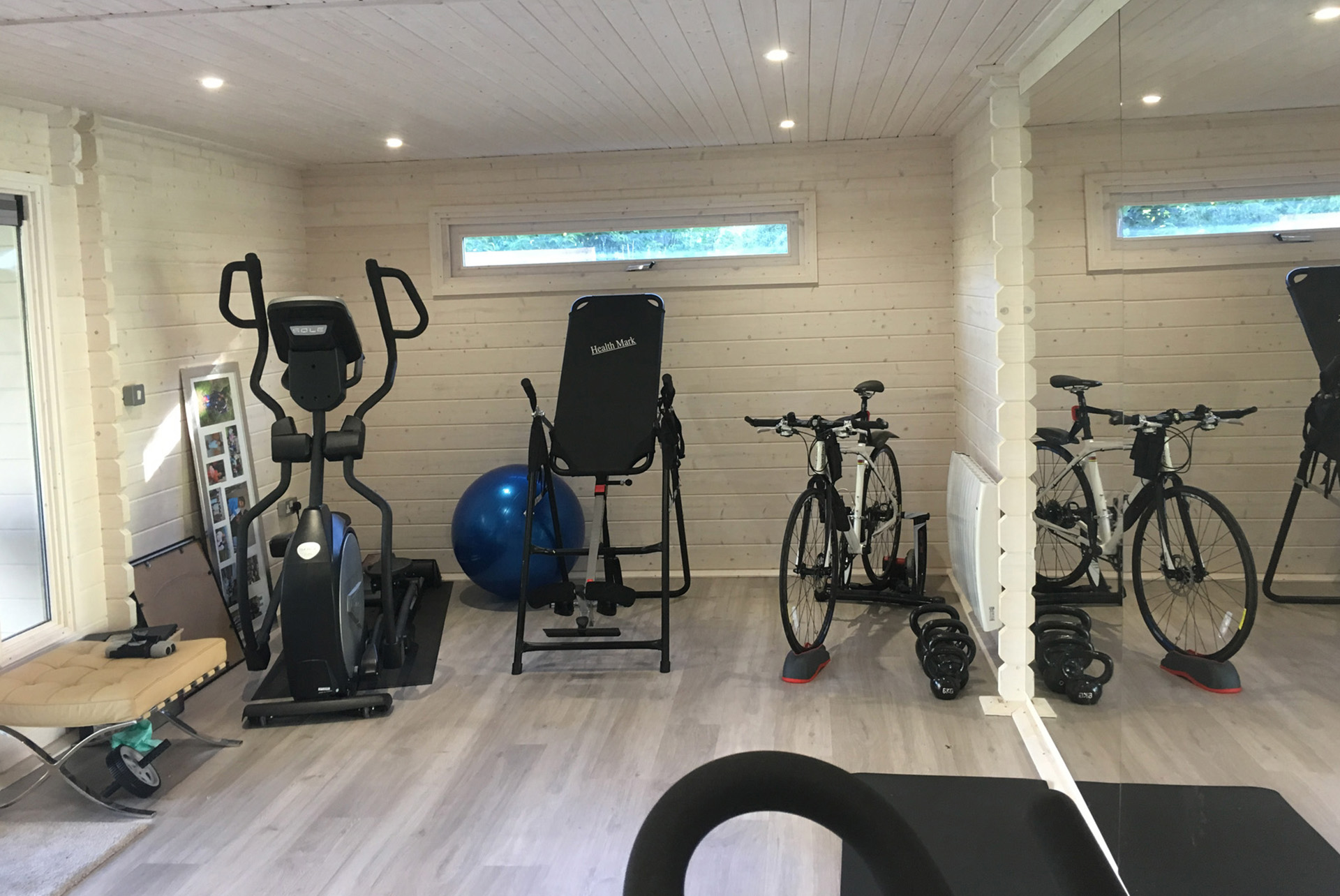 An example of a garden room transferred into a Home Gym with cardio and weight equipment
