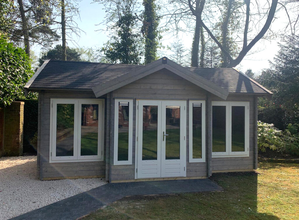 A beautiful Log Cabin in a garden, from Sutton Garden Buildings Bespoke Garden Rooms collection